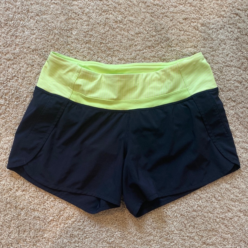 Black Lululemon shorts with neon waistband